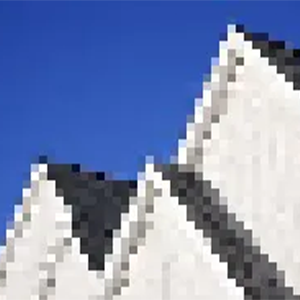 A pixelated image of rooftops against a sky